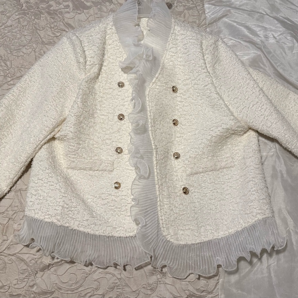 Cream Miss Rosier Blanche ruffle jacket.